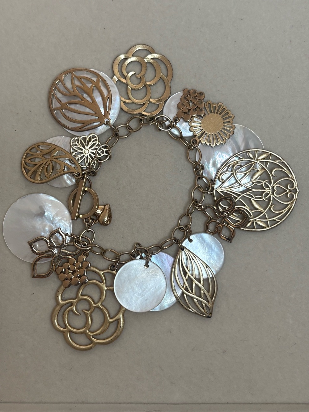 Carolee Gold Tone Mother of Pearl Floral Charm Bracelet